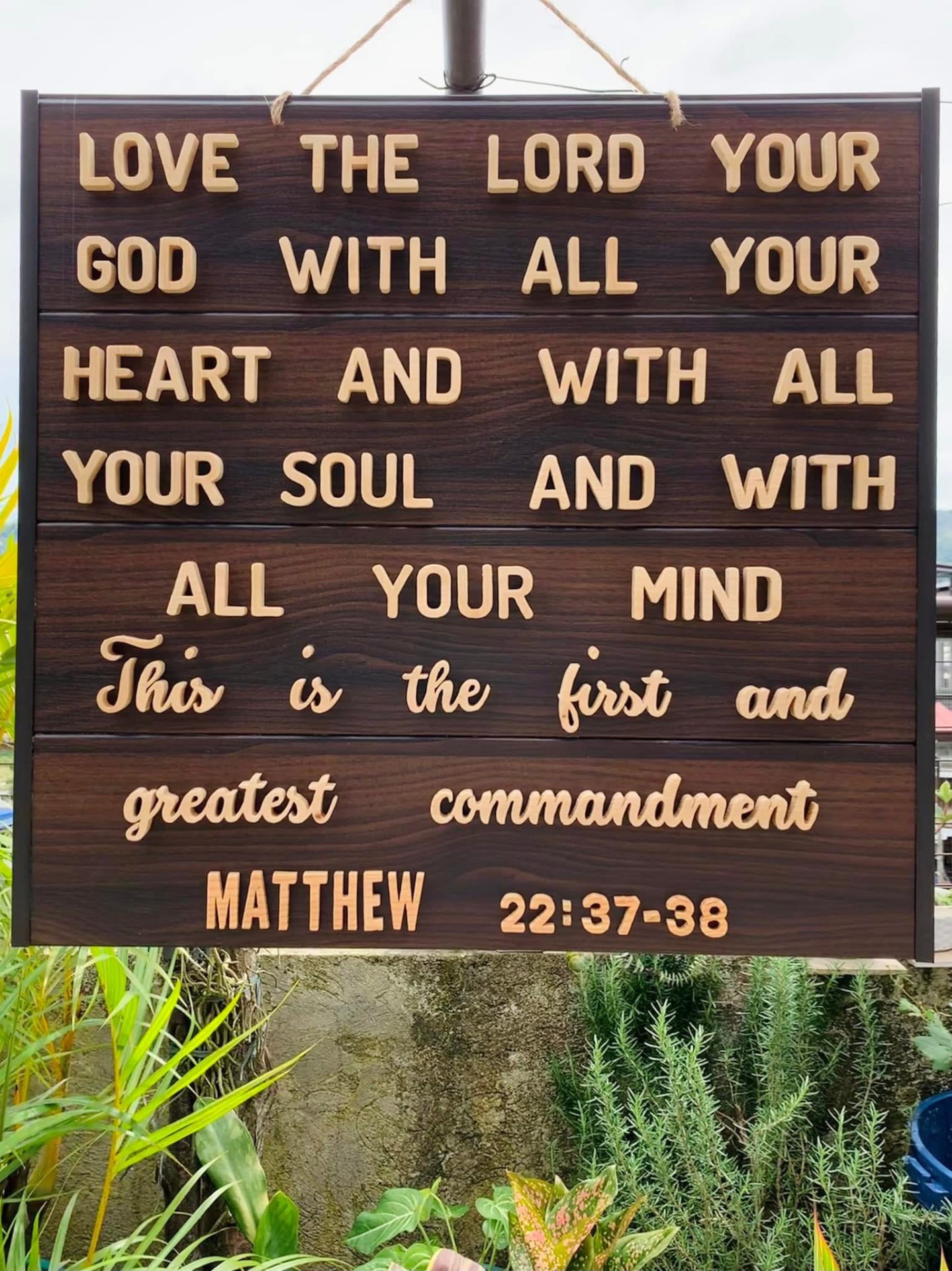 Large dark wood slat board with a full Bible verse in raised natural wooden letters